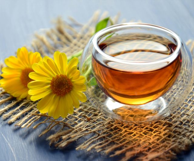 Clear Glass Bowl Beside Yellow Flower