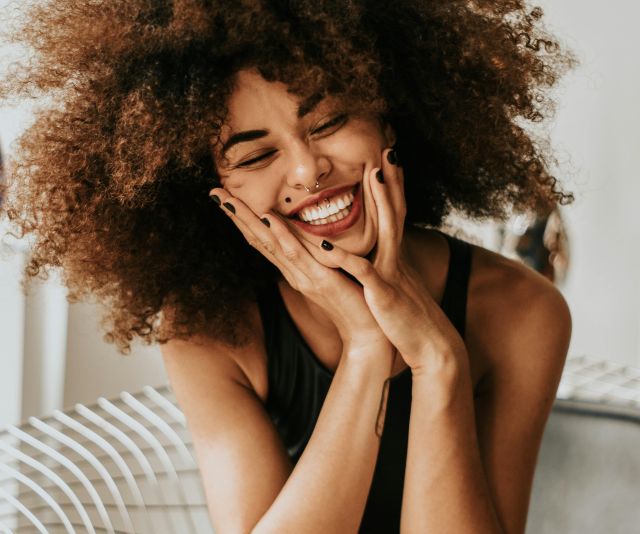 Woman Sitting And Smiling